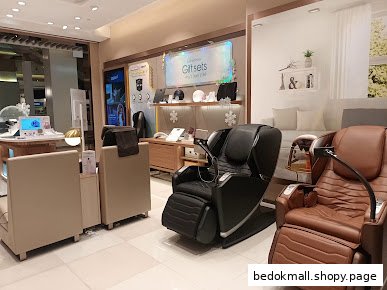 Interior view of an OSIM shop displaying massage chairs and other products.