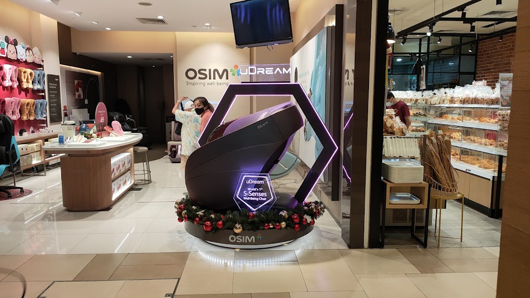 Interior view of an OSIM store with a large massage chair display.