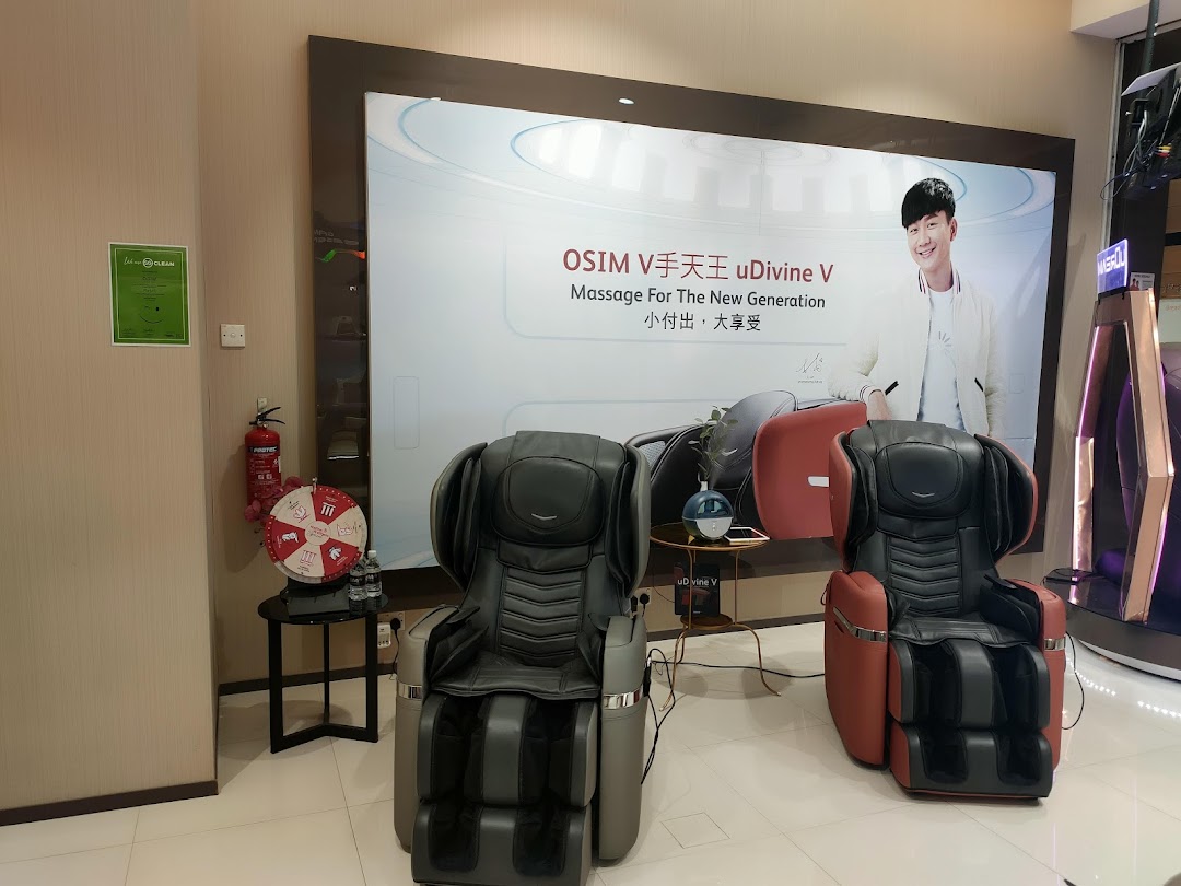 Interior view of OSIM shop displaying massage chairs and promotional backdrop.