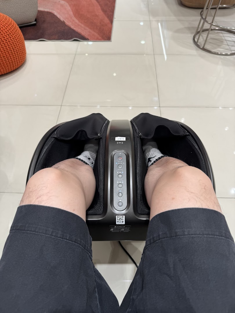 Person's legs in a foot massager inside a shop.