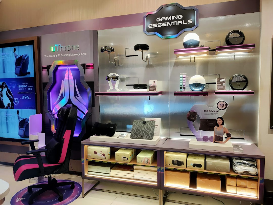 Interior shop display featuring a gaming massage chair and various wellness products.