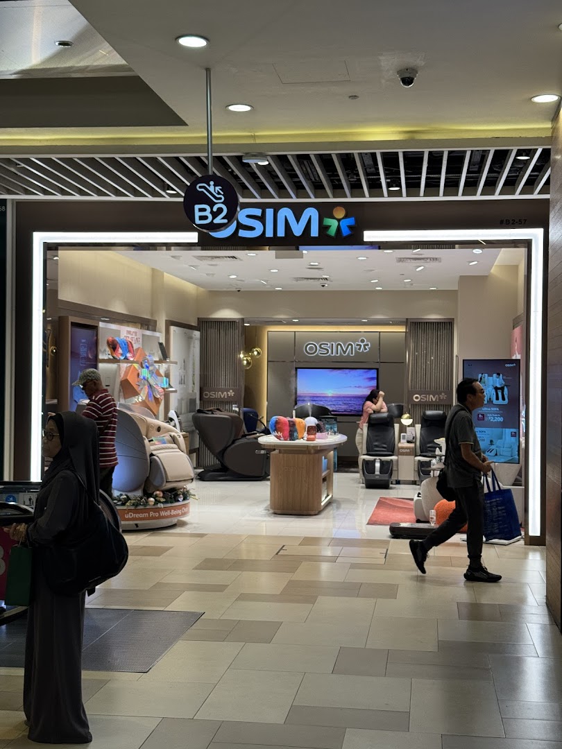 OSIM shop entrance from mall corridor, showing interior and customers.