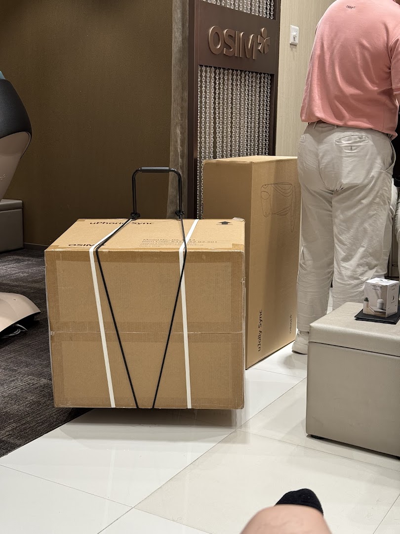 Large boxes and a person inside an OSIM shop.