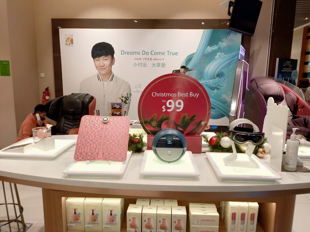 Interior shop display with OSIM products, promotional banner, and a staff member.