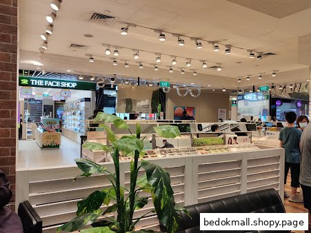 Interior view of a retail store with eyewear displays and customers.