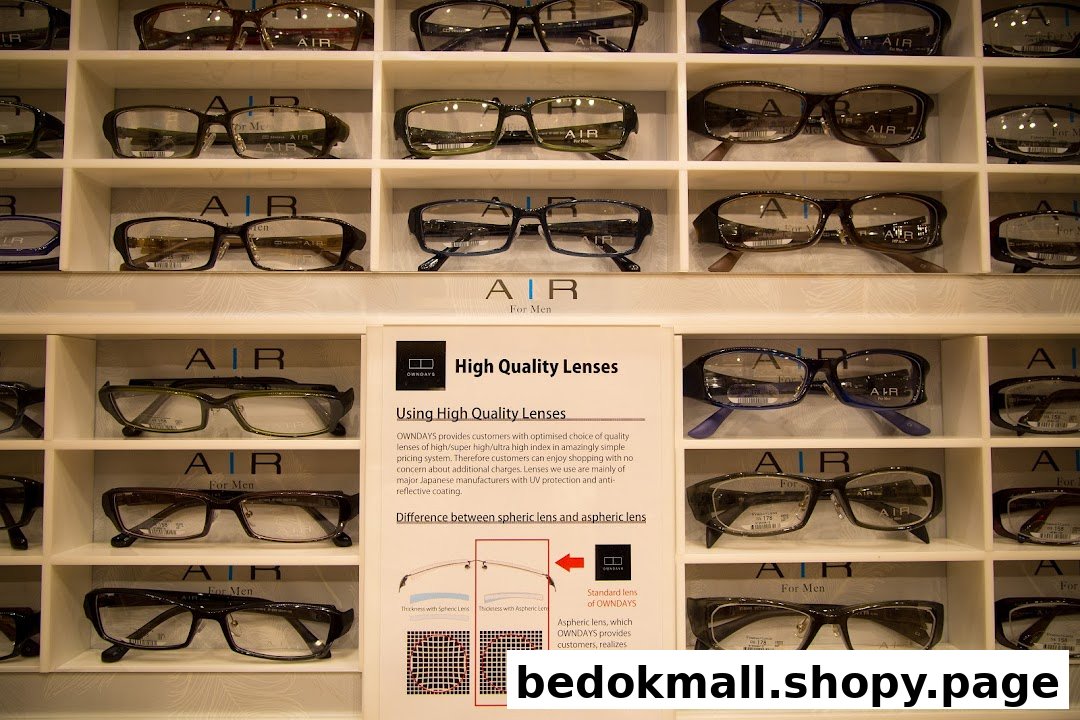 Display of eyeglasses on shelves with a sign explaining lens features.