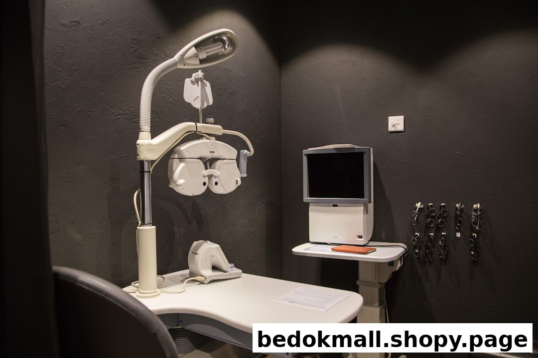 Eye examination equipment and monitor in a dark room.