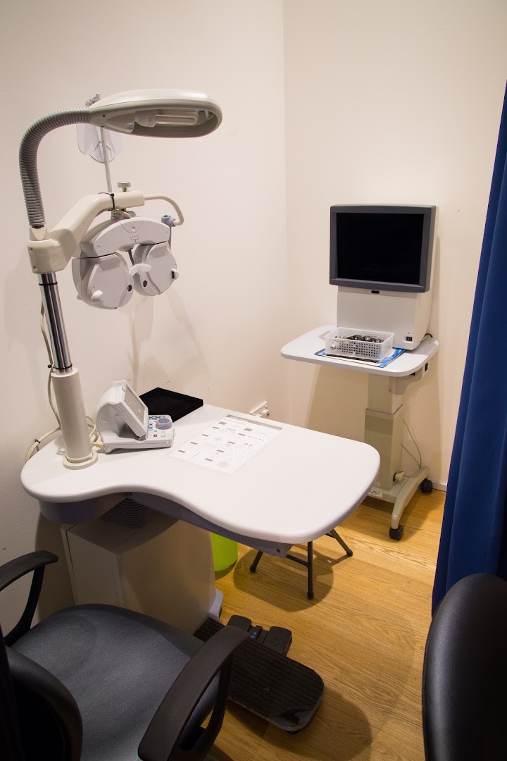Eye examination room with specialized optical testing equipment.
