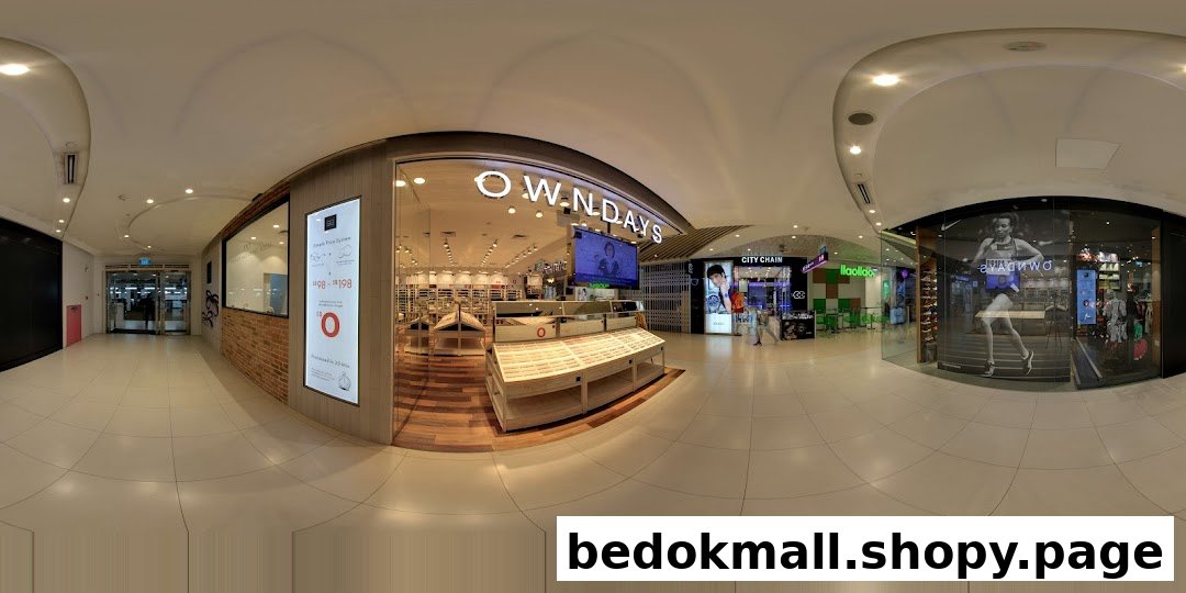 OWNDAYS shop front with glass displays and entrance in a mall corridor.