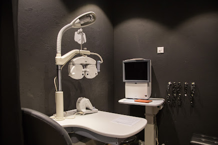 Interior shot of an eye examination room with optical equipment.