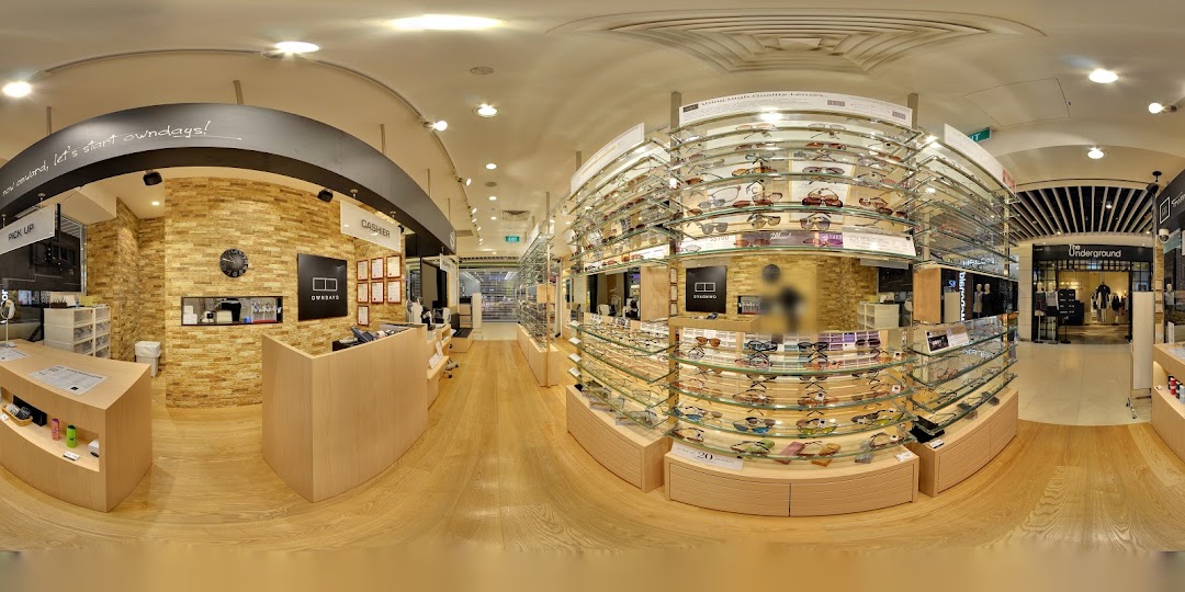 Spacious optical shop interior with numerous eyeglasses on display.