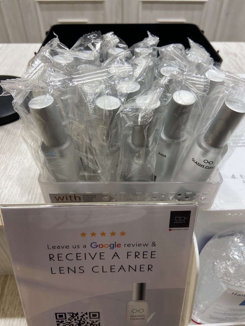 Display of lens cleaners and a sign offering free cleaner for a Google review.