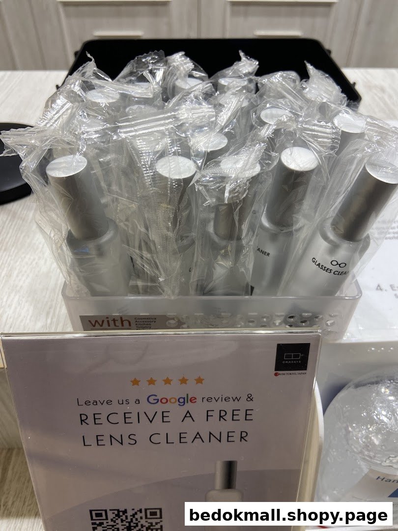 Display of lens cleaners and a sign offering free cleaner for a Google review.