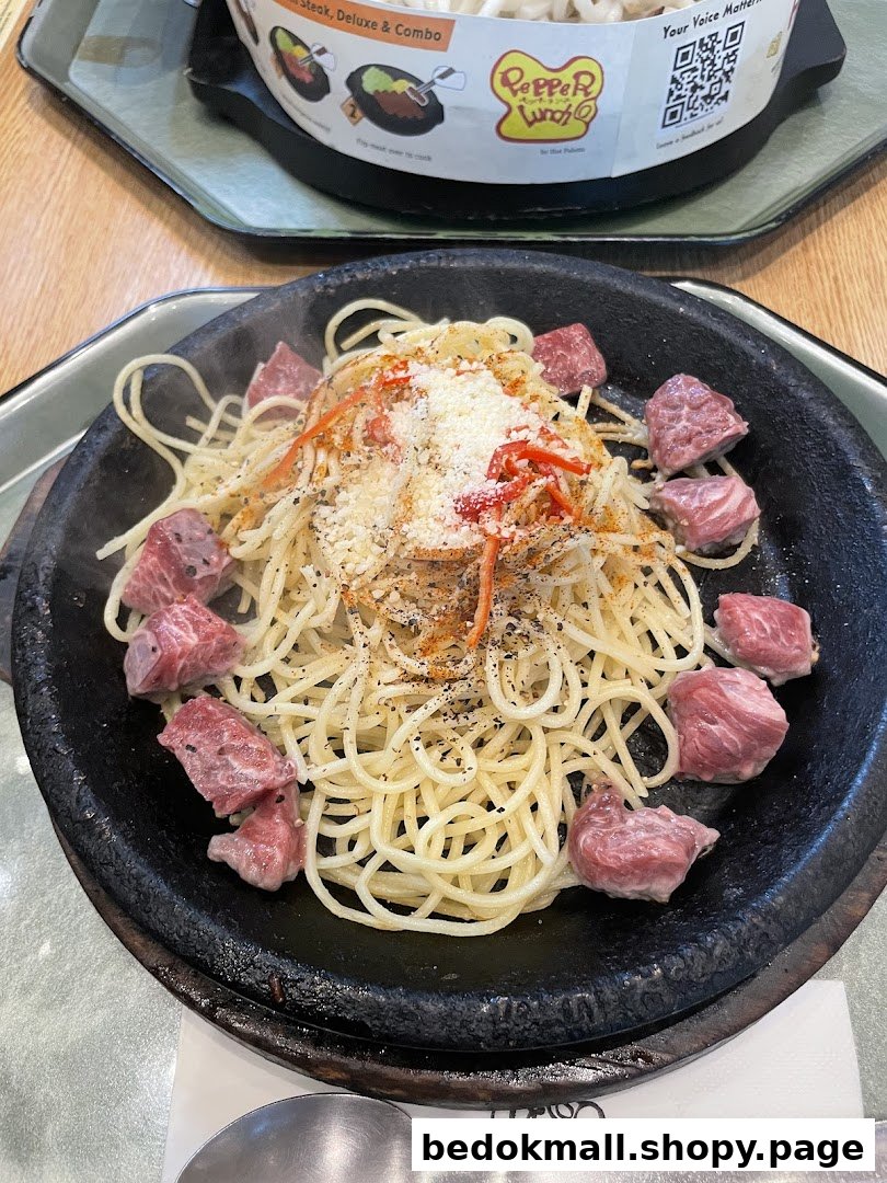 Spaghetti and beef on a hot plate at Pepper Lunch.