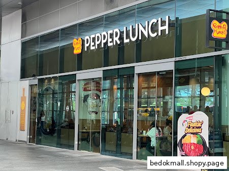 Exterior view of Pepper Lunch restaurant with glass entrance and signage.