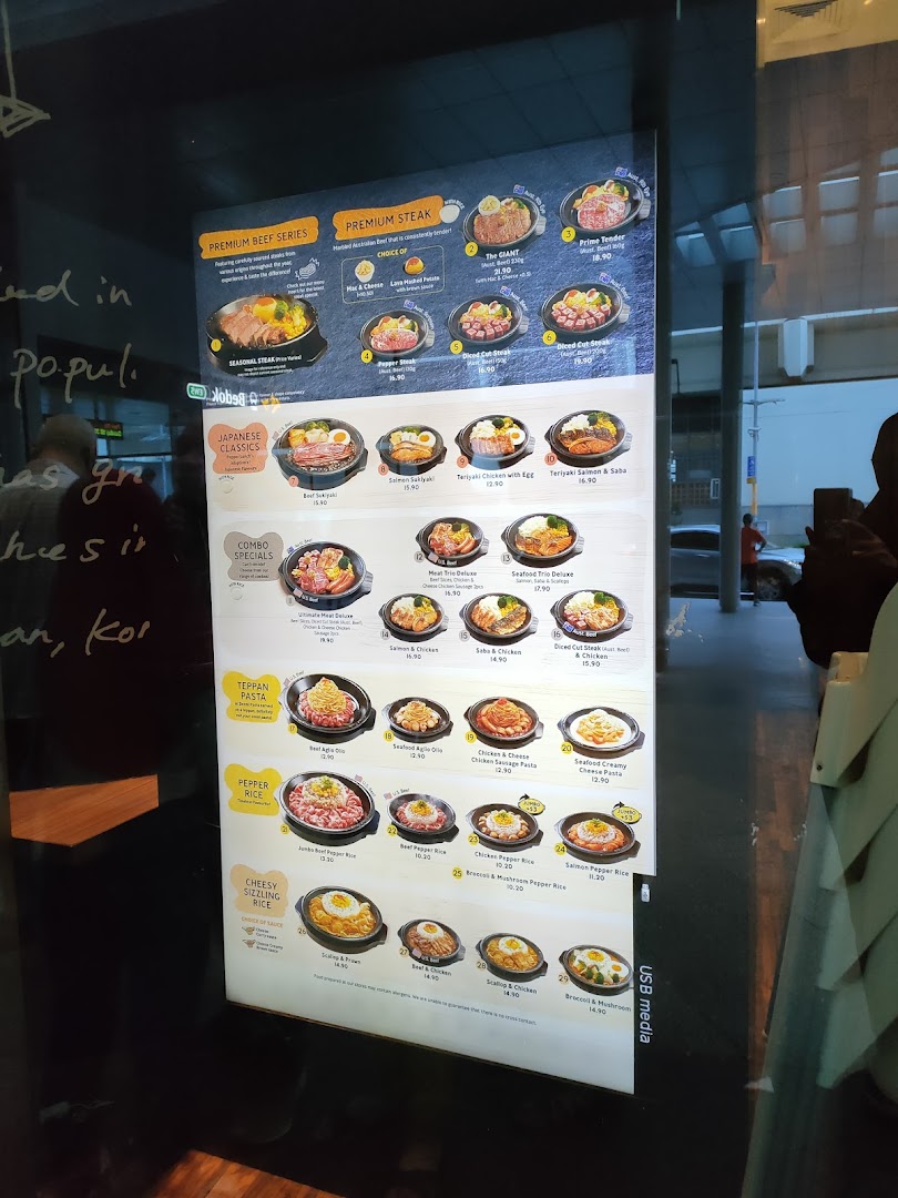 A digital menu board displaying various food items and prices.