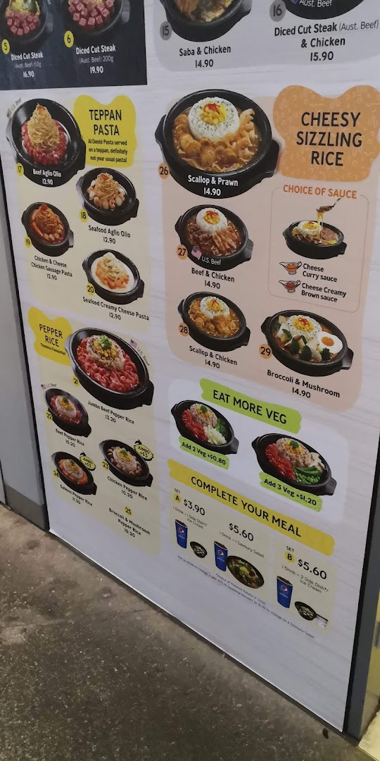 A large menu board displaying various food items, prices, and meal sets.