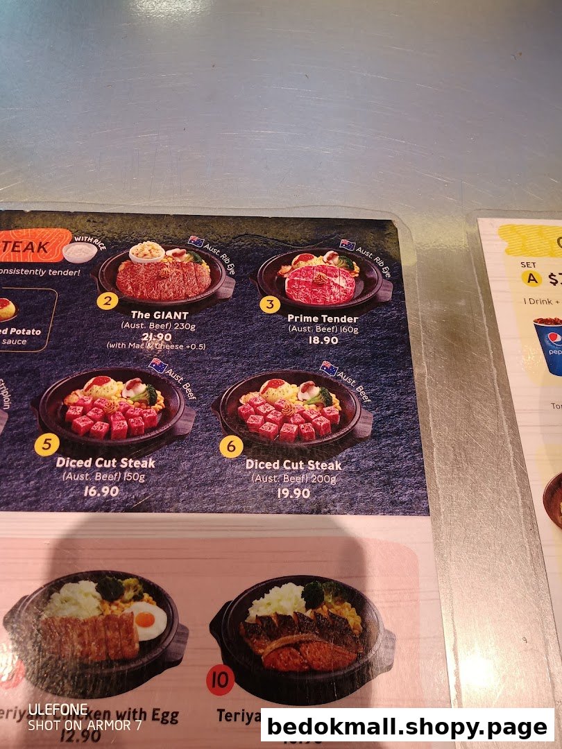 Close-up of a food menu displaying various dishes and prices.