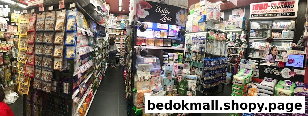Interior view of a pet shop with aisles of products and a cashier.