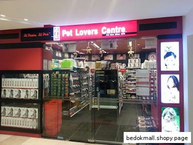 Exterior view of Pet Lovers Centre pet store with visible interior and signage.