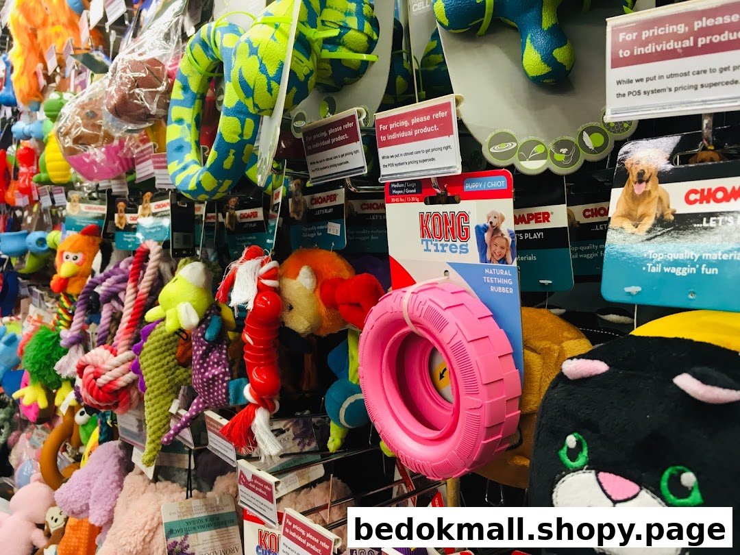 Close-up of a retail display featuring many colorful pet toys.