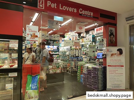 Pet Lovers Centre shop front with customers and pet supplies visible inside.
