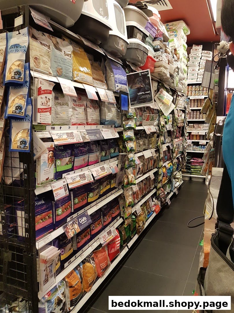 Aisle in a pet store with shelves stocked full of pet food and supplies.