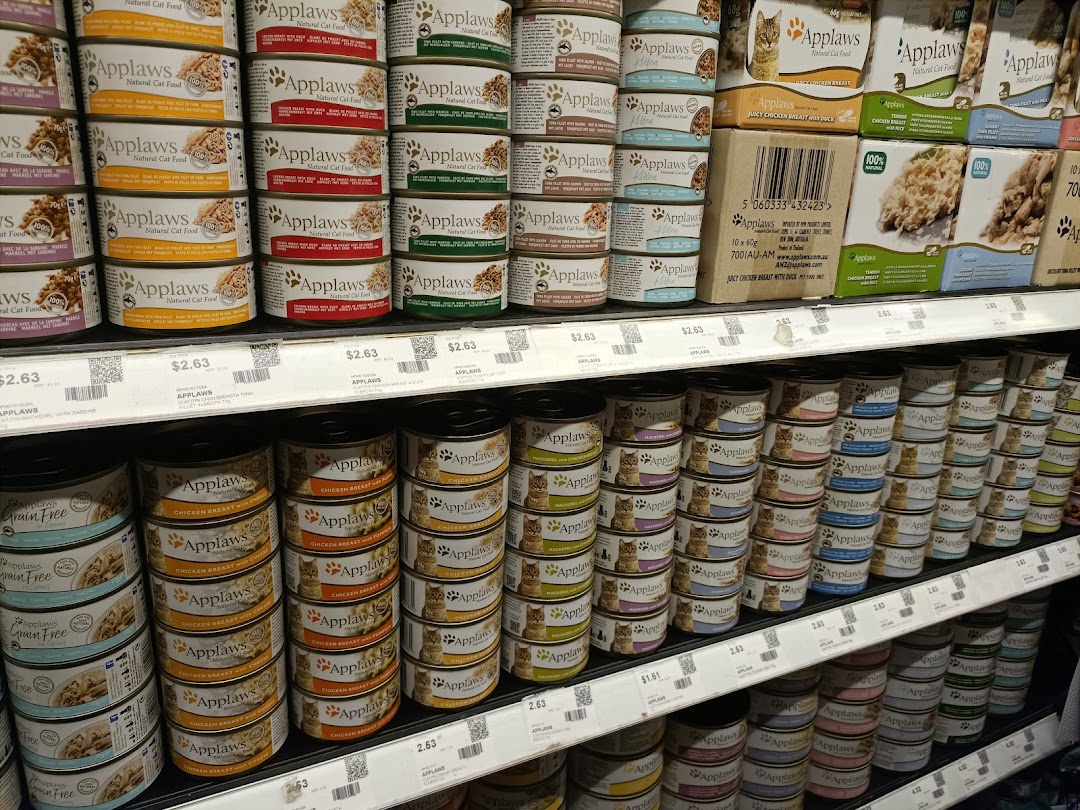 Shelves filled with various brands and types of canned pet food.