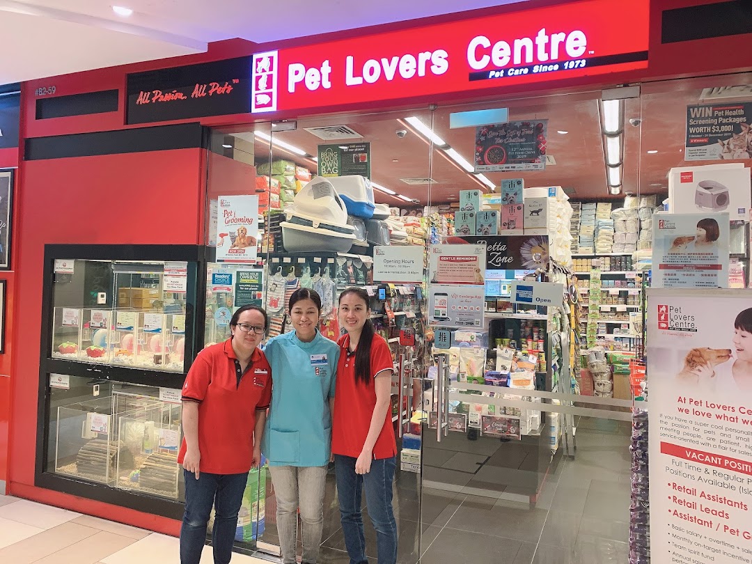 Pet shop entrance with staff and animal displays visible inside.