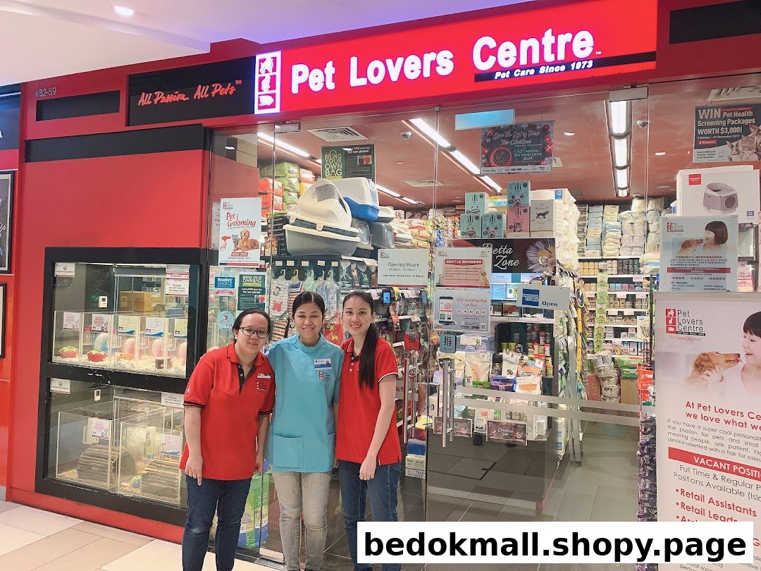 Pet shop entrance with staff and animal displays visible inside.