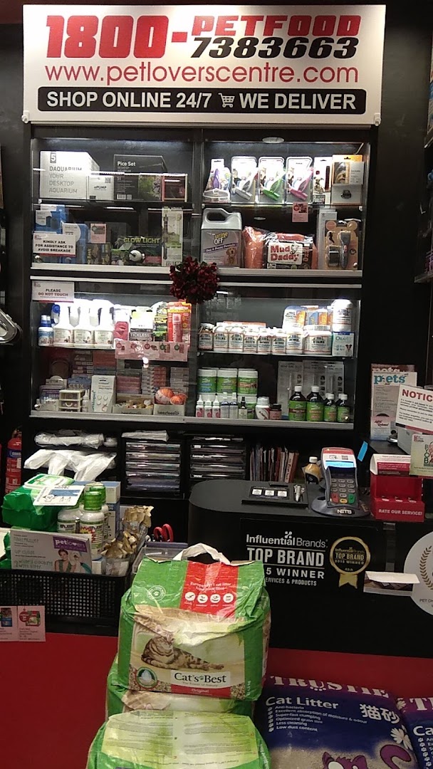 Interior view of a pet shop showing products on display and a counter.