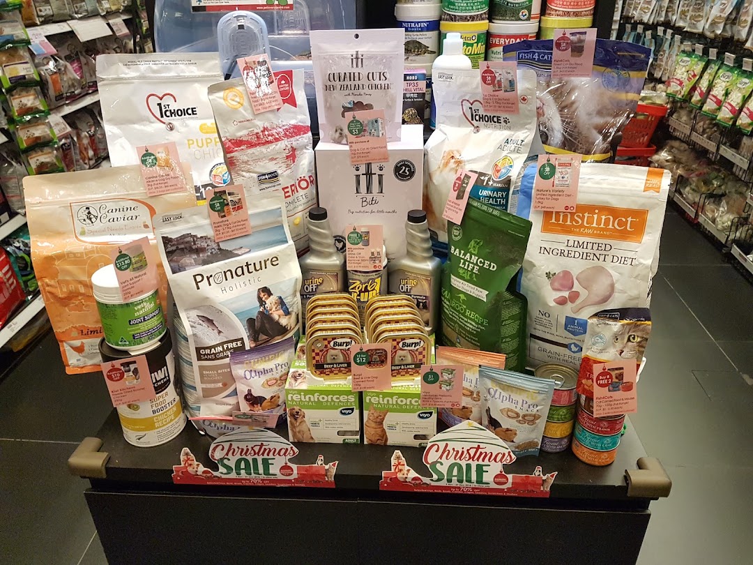 Pet food products on display in a retail store with sale signs.