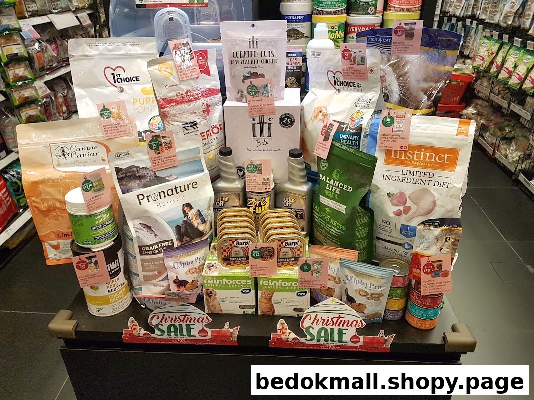 Pet food products on display in a retail store with sale signs.