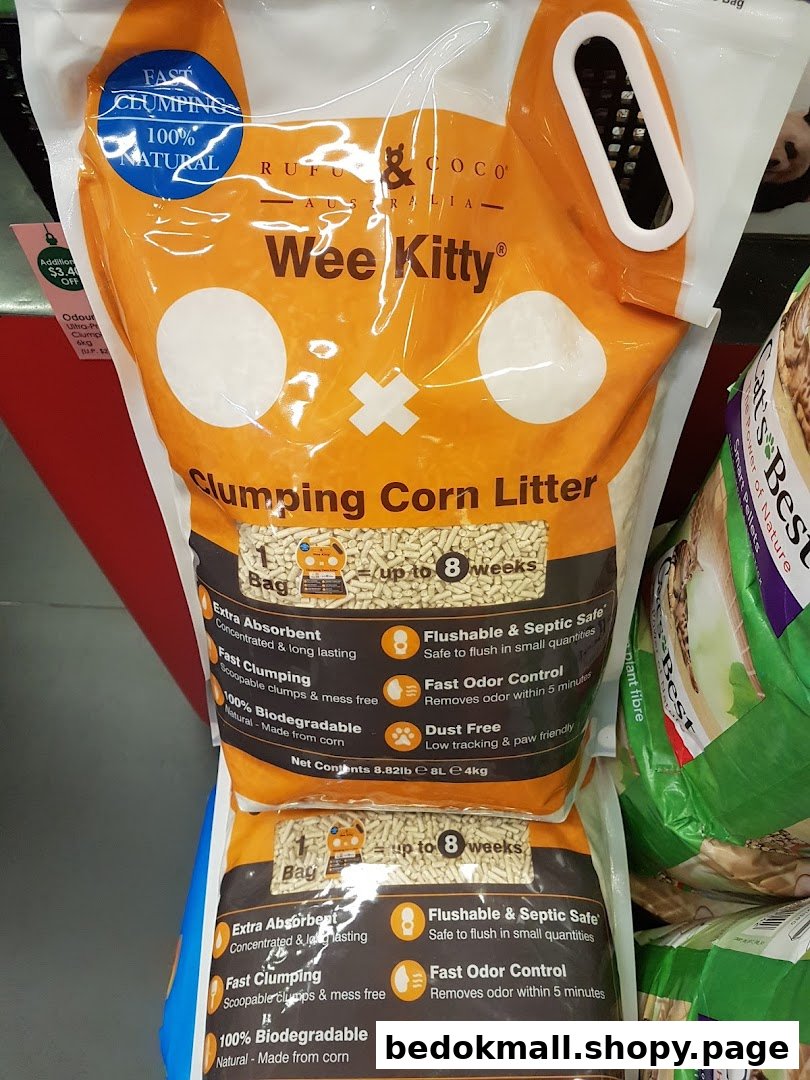 Bags of Wee Kitty clumping corn litter displayed on a retail shelf.