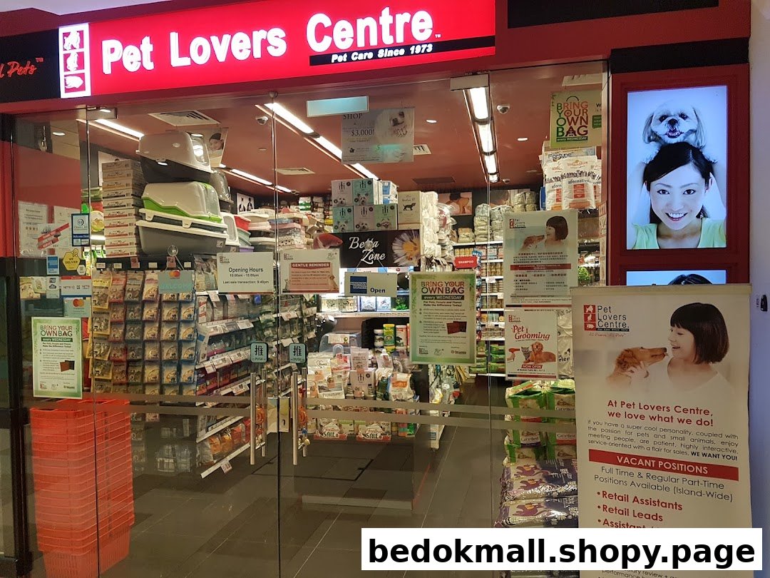 Entrance of a Pet Lovers Centre shop with red signage and glass doors.