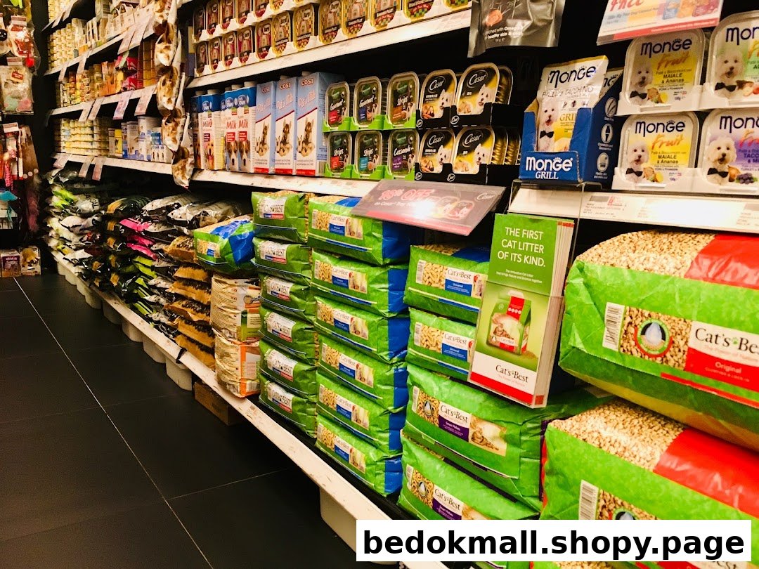 Aisle in a pet store with shelves stocked with pet food and litter.