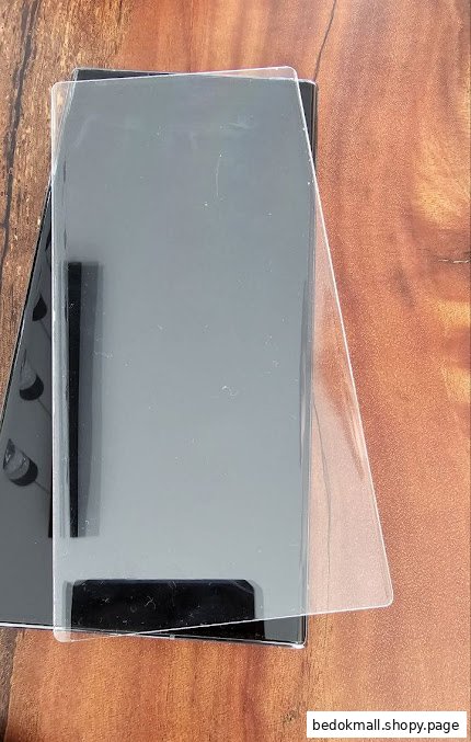A smartphone with a clear screen protector being applied.