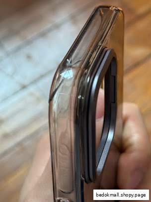 Close-up of a smartphone in a clear case with a metal ring holder.