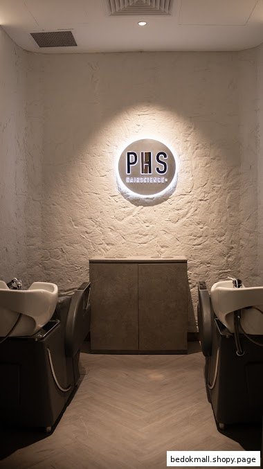 Interior of a hair salon with two washing stations and PHS Hairscience logo.