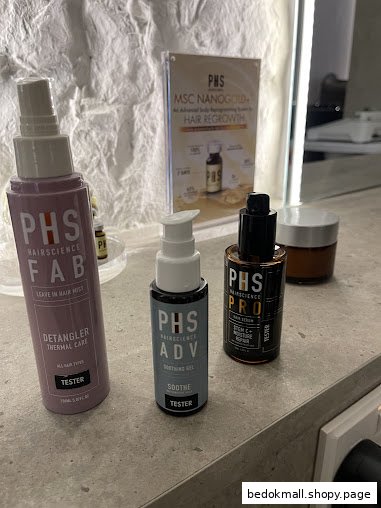 Hair care product testers and promotional display on a counter.