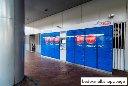 Blue POPStation parcel lockers with a central terminal in a public area.