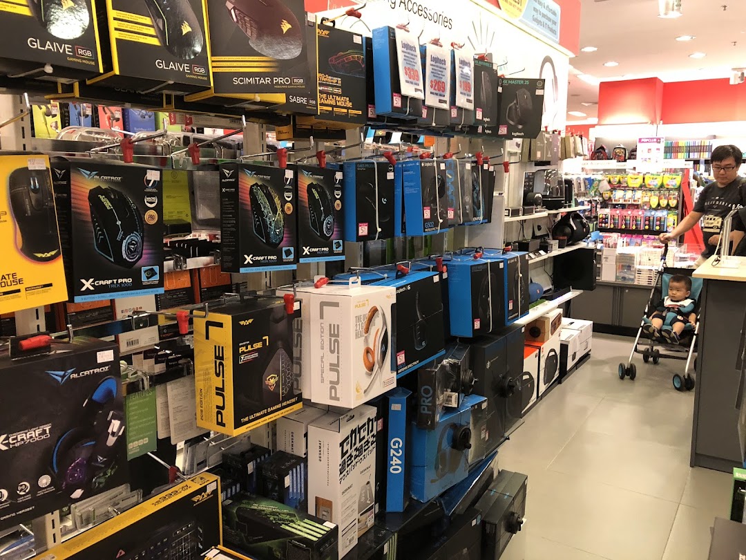 Interior view of a retail store aisle displaying packaged electronics and accessories.