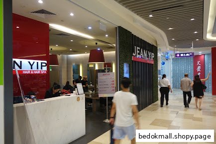 Exterior view of Jean Yip Hair & Hair Spa in a mall with people walking by.