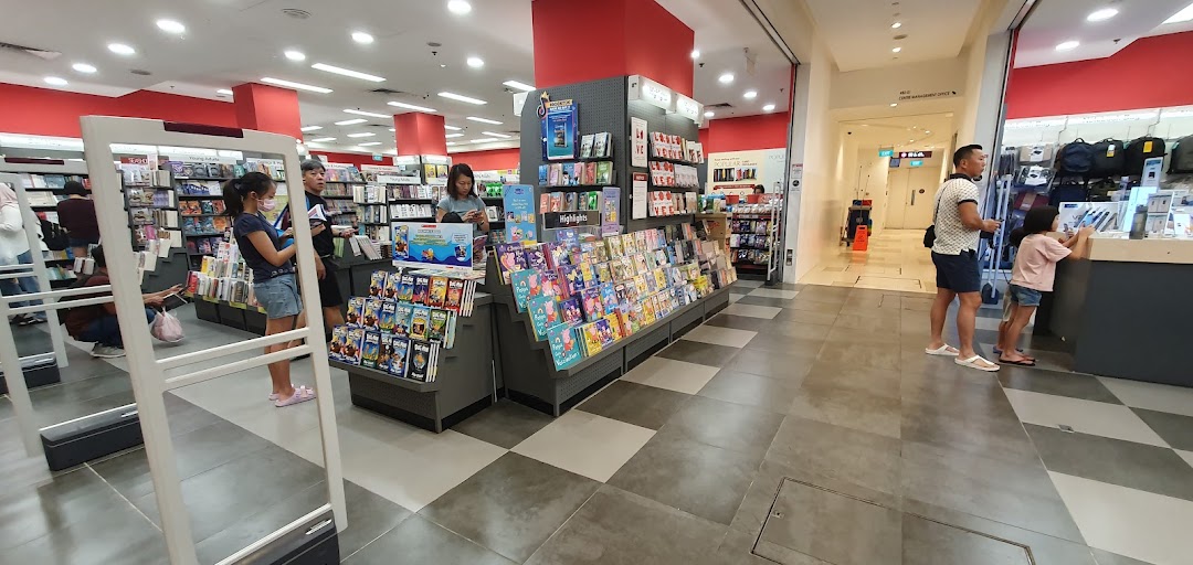 Interior view of a bookstore with people browsing books and displays.