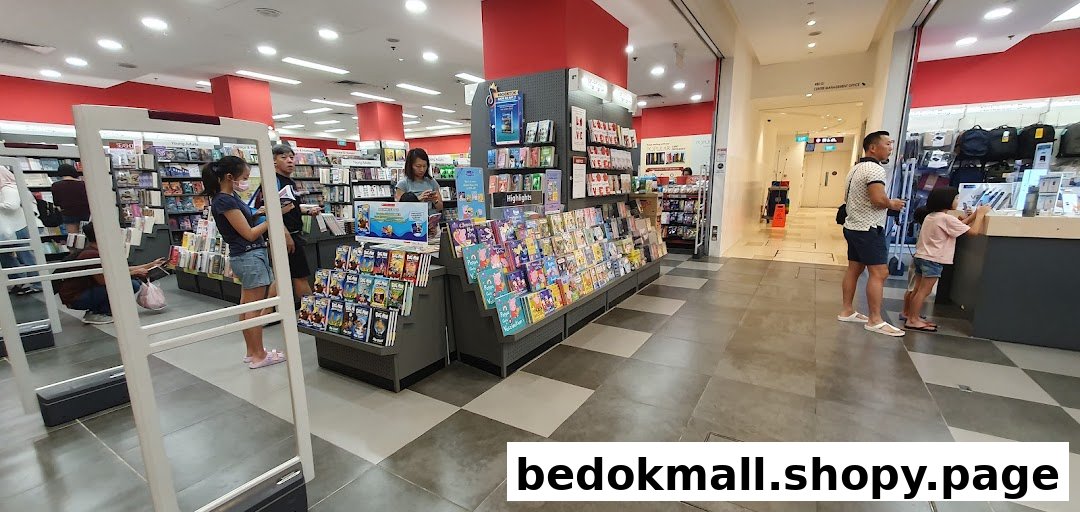 Interior view of a bookstore with people browsing books and displays.