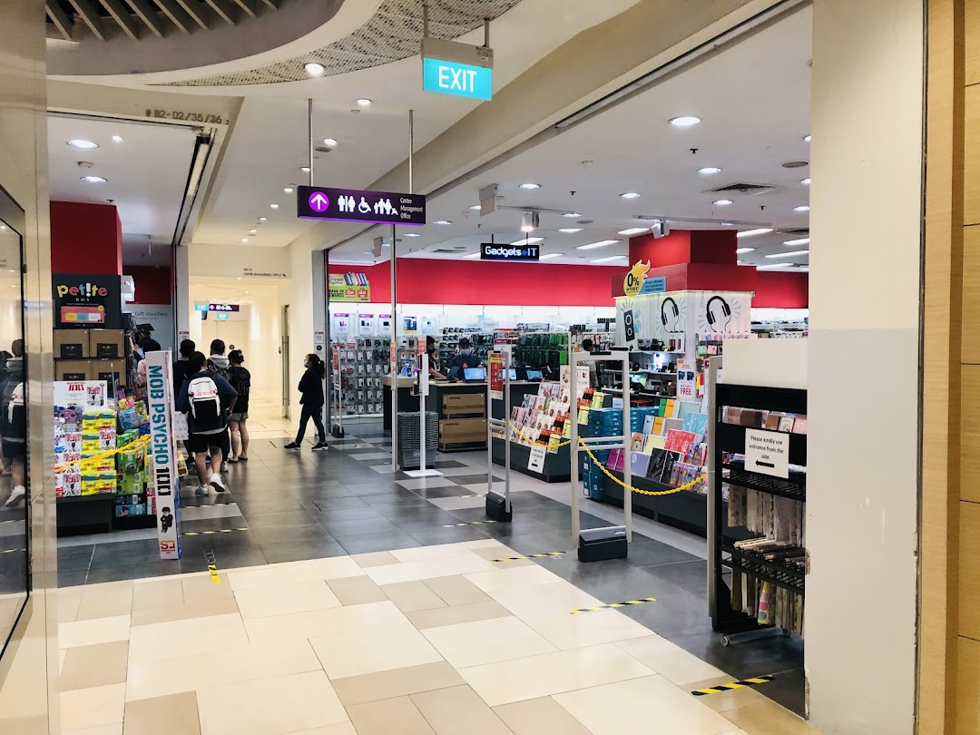 Interior view of a large retail store with various products and people.