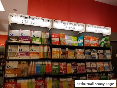 Shelves filled with examination papers and textbooks in a bookstore.