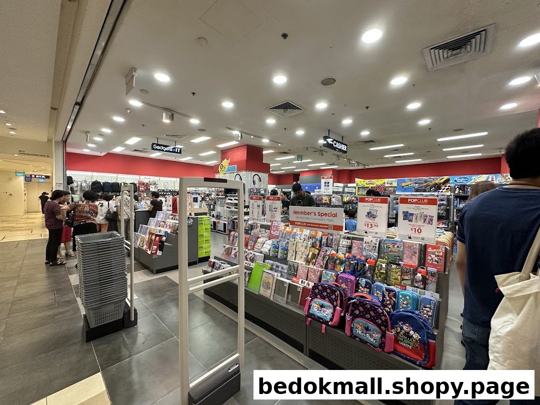 Interior view of a bookstore with various products on display and customers.