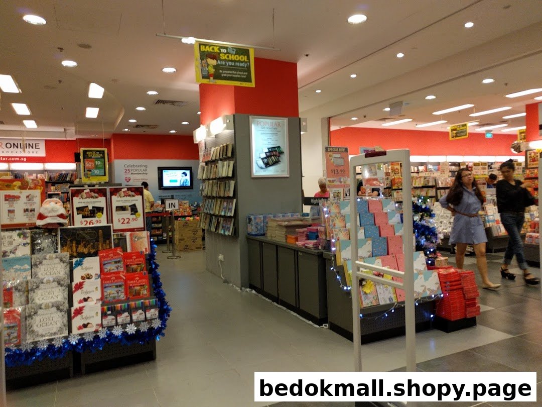 Interior view of a bookstore with books, displays, and customers browsing.