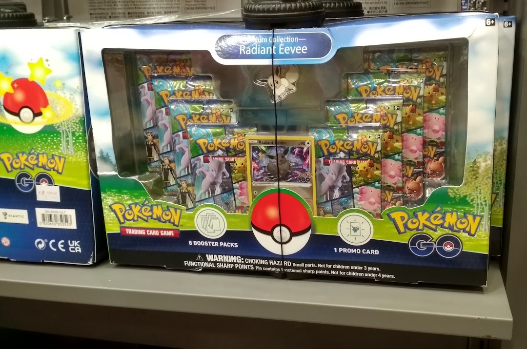 A Pokemon Trading Card Game box set featuring Radiant Eevee on a shelf.